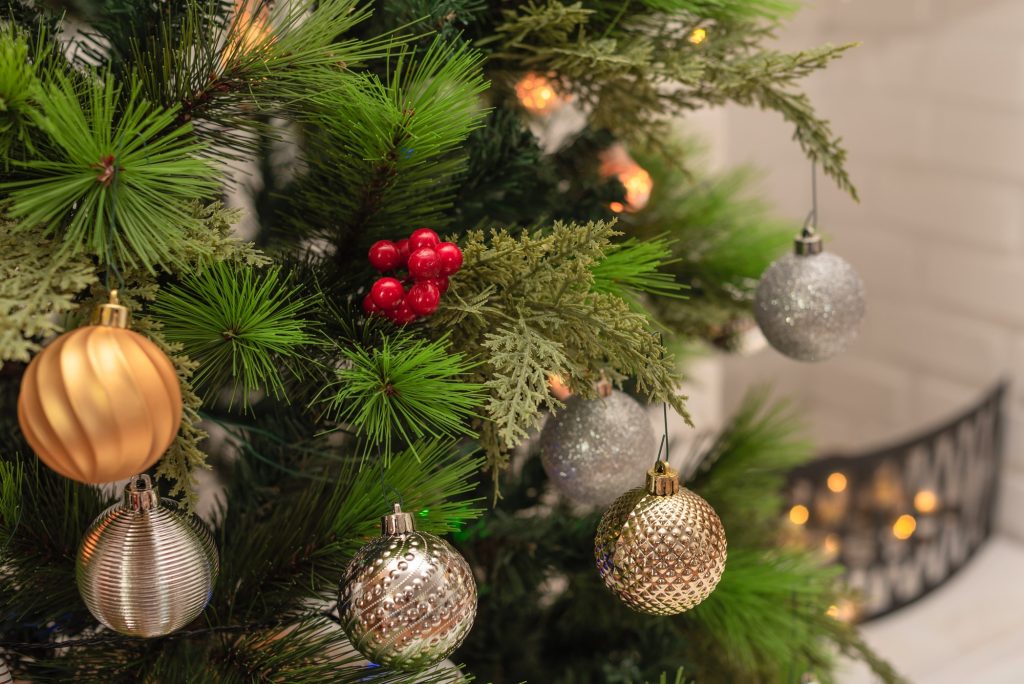 Christmas and New Year background. Close-up Xmas tree with decorations against blurred background